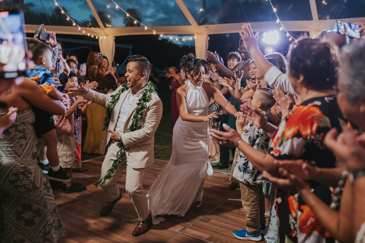 a couple walking through a reception at loulu palm